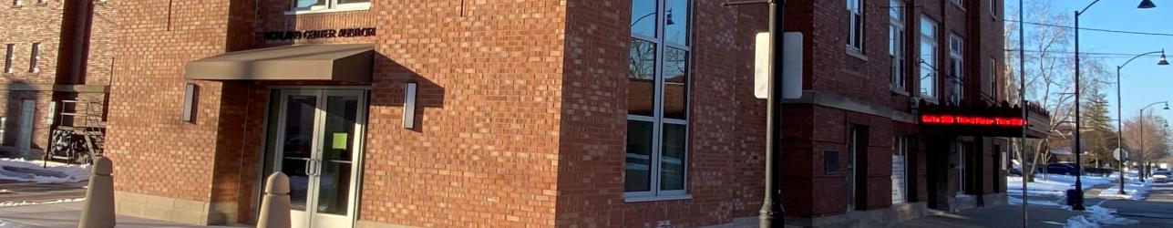 Tall brick building with blue sky background