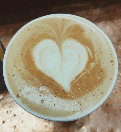 Latte on copper counter with latte art - a heart!
