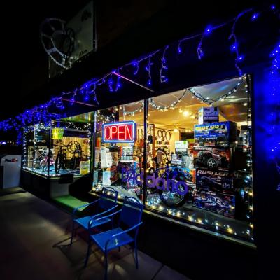 Front window of store at night with blue lights