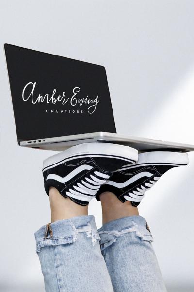 Picture of a laptop on feet that says Amber Ewing Creations