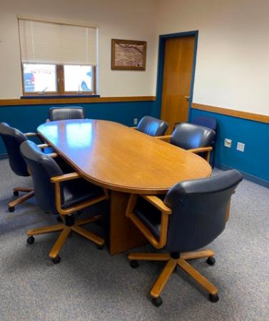 Conference room with an oblong table and six chairs