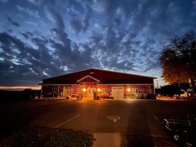 Oakwood Fruit Farm storefront at night.