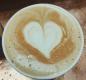 Latte on copper counter with latte art - a heart!
